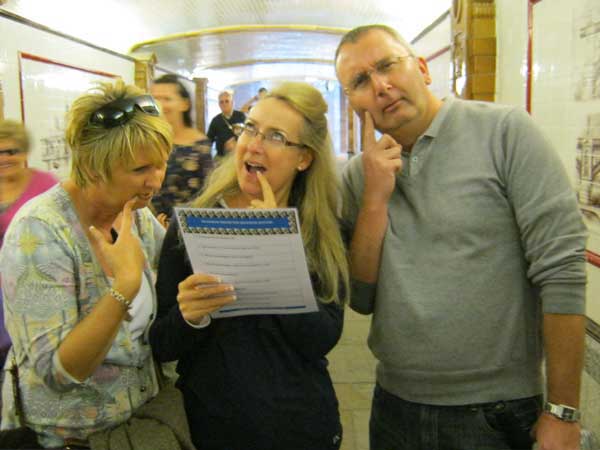 Three people thinking about a clue on the London Bridge Treasure Hunt.