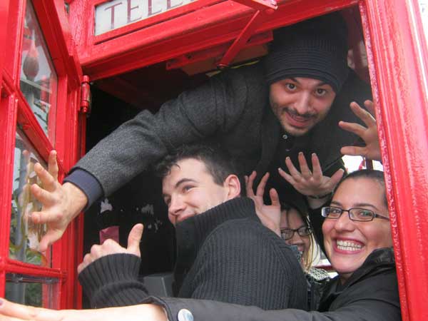 A team posing in a phone box as part of their South Bank Treasure Hunt.